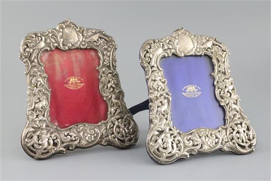 A pair of Edwardian repousse silver mounted photograph frames, by Goldsmiths & Silversmiths Co Ltd,
